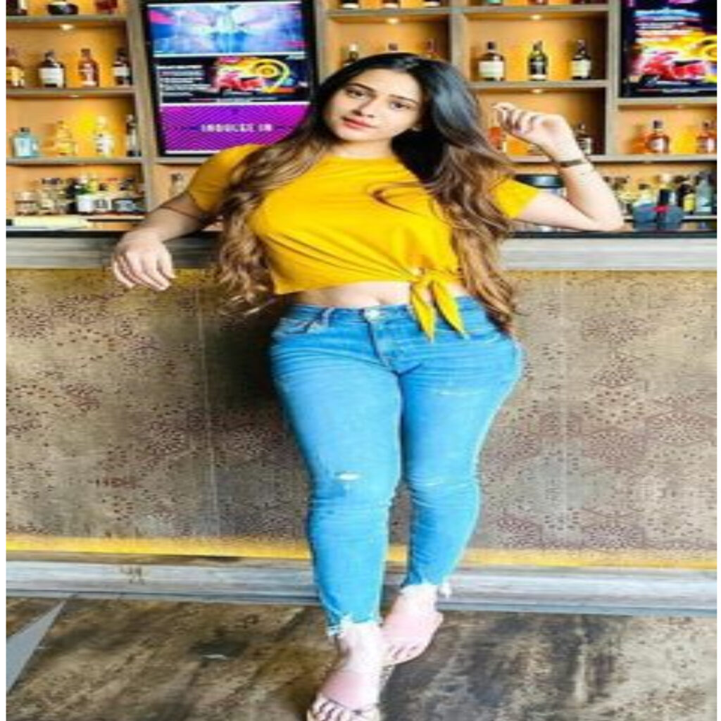 A VIP GIRL 22 YEARS OLD NAME IS REENA WEARING YELLOW AND BLUE JEANS STANDING NEAR WINE BAR