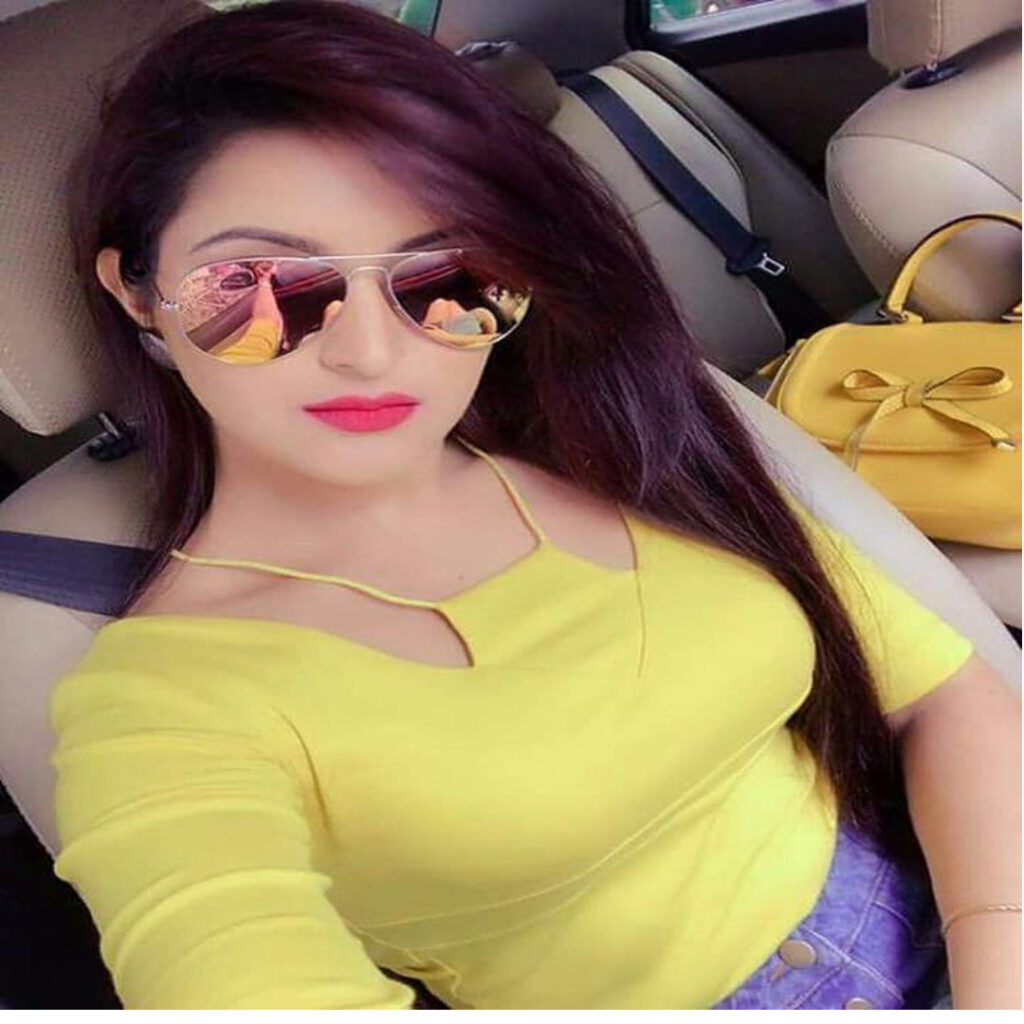 A GIRL 23 YEARS OLD NAME IS ELIYANA IN YELOW DRESS WITH LONG HAIR SITING POSITION IN THE CAR TAKING SELFIE