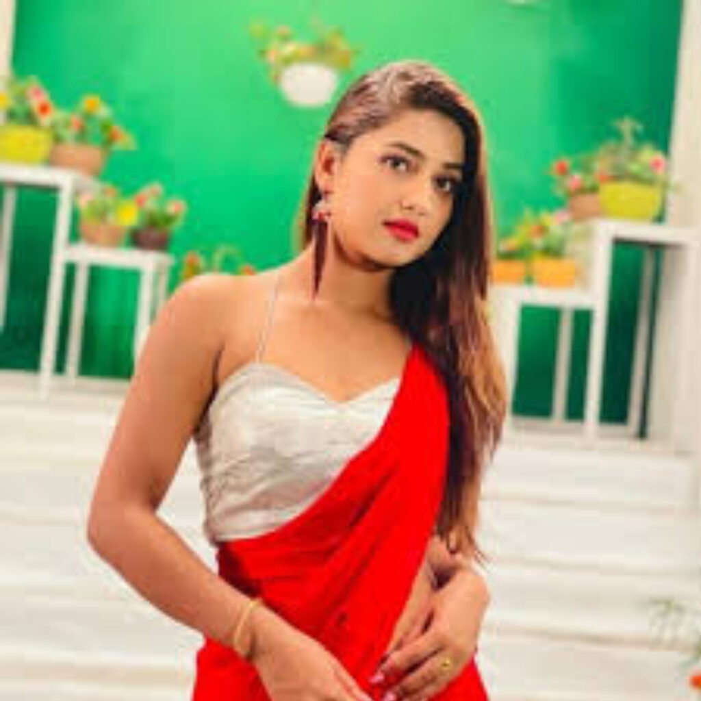 A GIRL 23 YEARS OLD NAME IS KOMAL WAERING RED SAREE AND WHITE BLOUSE GIVING SEXY POSE IN STANDING POSITION